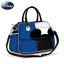 Disney Mickey Mouse Designer Carryall Purse Stylish Disney carryall with iconic symbol of Mickey Mouse's head and ears in black silhouette. Metallic Mickey Mouse charm. Magnetic closure.
Measures 15-1/2" W x 11" H x 5-1/4" D