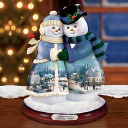 Thomas Kinkade "Snow Happy Together" Musical Figurine Handcrafted musical snowman couple figurine. Displays a montage of 6 Thomas Kinkade winter masterpieces. Textured trim. Plays "Joy to the World."
Measures 8" H