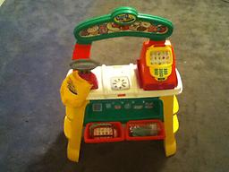 Fisher price smart shopper push buttons on register and talks. comes with food and bag